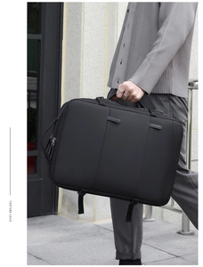 Detail view of the black textured business laptop bag with a reinforced handle and metal zipper