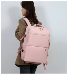 Detailed back view of pink large capacity travel backpack on model showing strap design