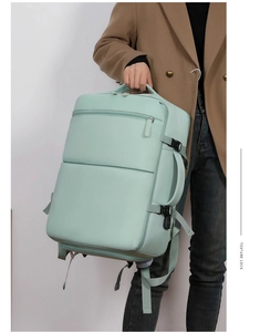 Detail of mint green travel backpack with multi-layer zippers and waterproof texture