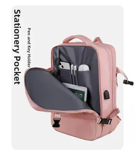 Detail view of pink laptop backpack interior with pen slots and key attachment hook