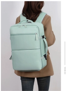 Rear view of mint green laptop backpack with ergonomic straps and side handle for travel