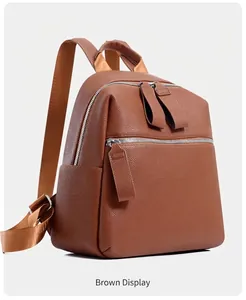 Detailed view of the brown lychee-textured PU leather backpack with silver zippers