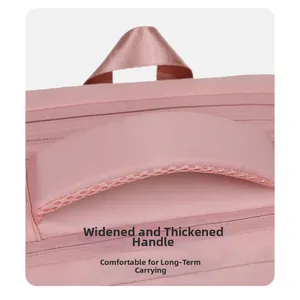 Detail view of the wide padded pink laptop bag handle with breathable mesh and nylon loop