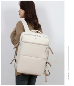 Detail view of the cream business backpack side strap and textured modern fabric finish
