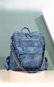 Detailed macro view of the blue PU leather backpack featuring vibrant woven strap details