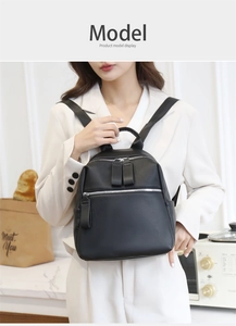 Detail view of black lychee grain PU leather backpack with double front zipper pockets