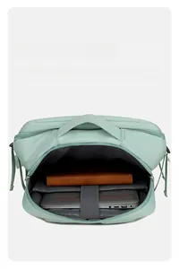 Detail view of mint green laptop compartment with protective padding and elastic strap