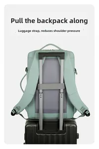 Travel backpack detail showing luggage strap fixed on suitcase handle for easy carrying