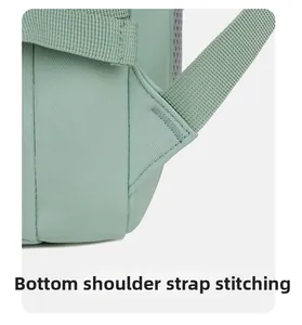 Close-up of reinforced bartack stitching on mint green travel backpack straps