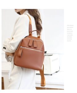 Detail view of brown lychee texture PU leather backpack showing side-back wearing effect