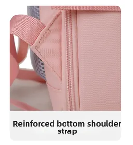 Close-up of bartack stitching and reinforced pink nylon strap on the backpack