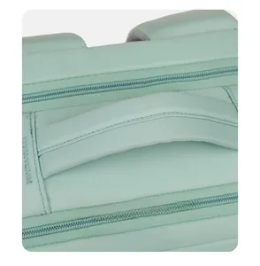 Detail view of the thickened carry handle and dual zippers on a light green travel backpack