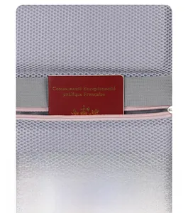 Close-up of the back zipper pocket on grey mesh backpack holding a red passport