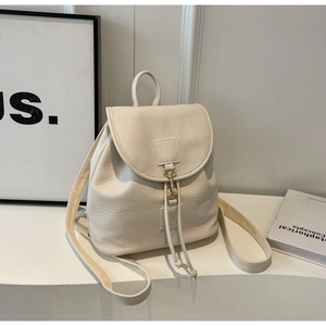 Detail of off-white lychee textured PU leather backpack with metal hook and drawstring