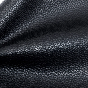 Gros plan sur le cuir PU noir à texture de grain litchi avec une finition mate sophistiquée