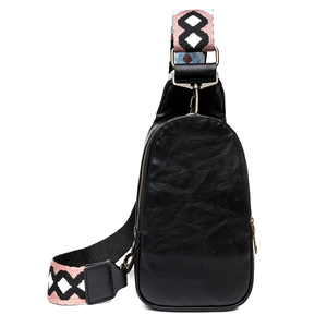 Close-up of black leather chest bag featuring a colorful geometric woven shoulder strap