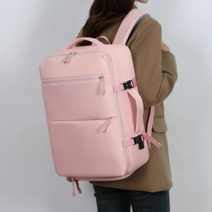 Pink multipurpose waterproof travel backpack with breathable mesh straps shown on model