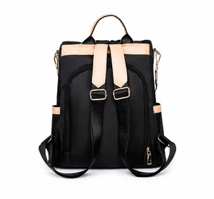 Detail of nylon backpack back view featuring hidden zipper pocket and beige straps