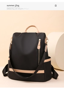 Detail view of the black nylon backpack showing contrast beige leather trim and vertical zipper