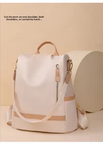 Detail of beige nylon backpack showing versatile top handle and vertical zipper pocket