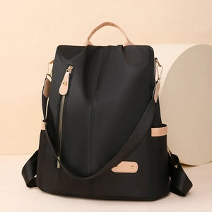 Detail of waterproof nylon backpack with beige leather handles and vertical zipper