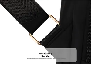 Detail of golden hardware buckle with ergonomic triangle reinforcement on black nylon bag