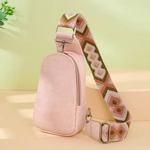 Detail of pink PU leather chest bag featuring adjustable geometric jacquard woven strap