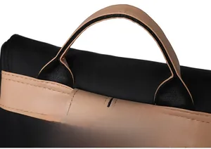 Detail of reinforced leather handle and nylon stitching on the minimalist backpack