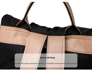 Close-up of meticulous stitching on black nylon backpack with brown leather trim