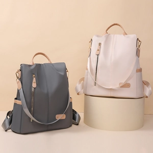Minimalist nylon backpacks in grey and cream with leather handles and versatile straps