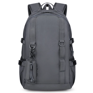 Close-up of a dark grey hiking backpack featuring a detachable small zipper pouch and webbing
