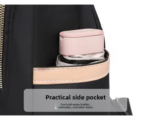 Detailed view of nylon backpack side pocket featuring a light pink trim and a folding umbrella