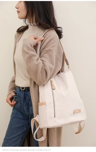 Detail view of large capacity nylon backpack for women in beige with side pocket