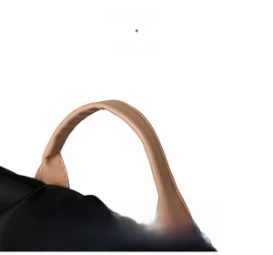 Close-up of comfortable beige faux leather handle and black nylon fabric on backpack