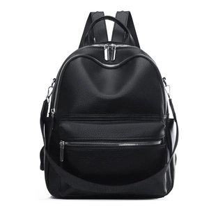 Detail of black faux leather backpack with pebble texture and detachable shoulder strap