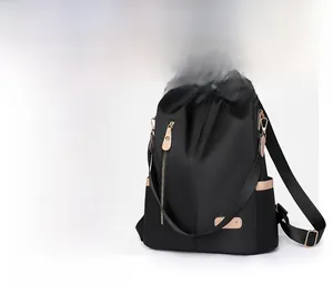Close-up of minimalist nylon backpack showing two-tone contrast and side pocket detail