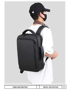 Side view of black business travel backpack with padded straps and sleek matte finish