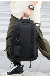 Detail of black tactical nylon backpack with MOLLE system webbing and side buckle straps