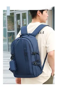 Detail of navy blue hiking backpack with Molle system straps and a side accessory pouch