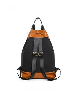 Back view of oxford cloth backpack featuring brown leather trim and adjustable straps