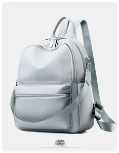 Detail shot of the light green PU leather texture and silver zipper on the backpack