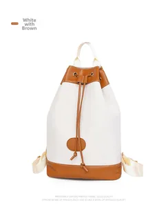 Detail of white Oxford fabric backpack with brown leather drawstrings and trim contrast