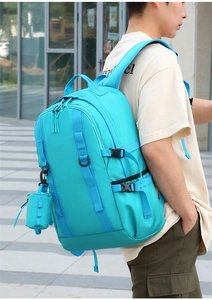 Detail of hiking backpack with side buckles, mesh pockets, and mini hanging pouch