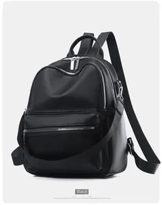 Detailed view of the black PU leather backpack with multiple silver zipper compartments