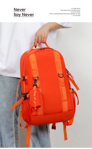 Detail of orange waterproof travel backpack with side straps and detachable small pouch