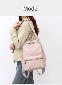 Side view of pink PU leather backpack showing lychee texture and silver zipper detail