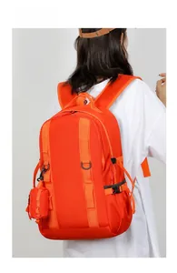 Detail of orange waterproof travel backpack with side mini pouch and reinforced straps