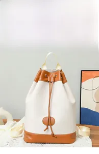 Detail of drawstring closure and contrast leather texture on beige casual backpack