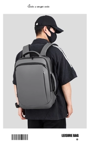 Grey business backpack detail showing waterproof matte fabric and side carry handle