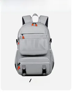 Front detail of grey backpack featuring orange zipper accents and breathable mesh pocket
